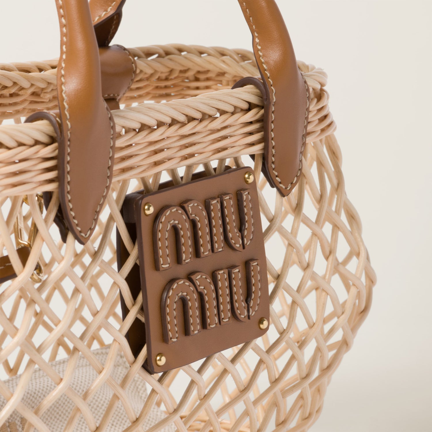 Woven fabric handbag with leather trim